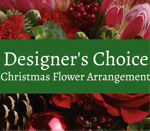 Christmas flower arrangement with red roses, pinecones, berries, and pink flowers labeled Designer's Choice