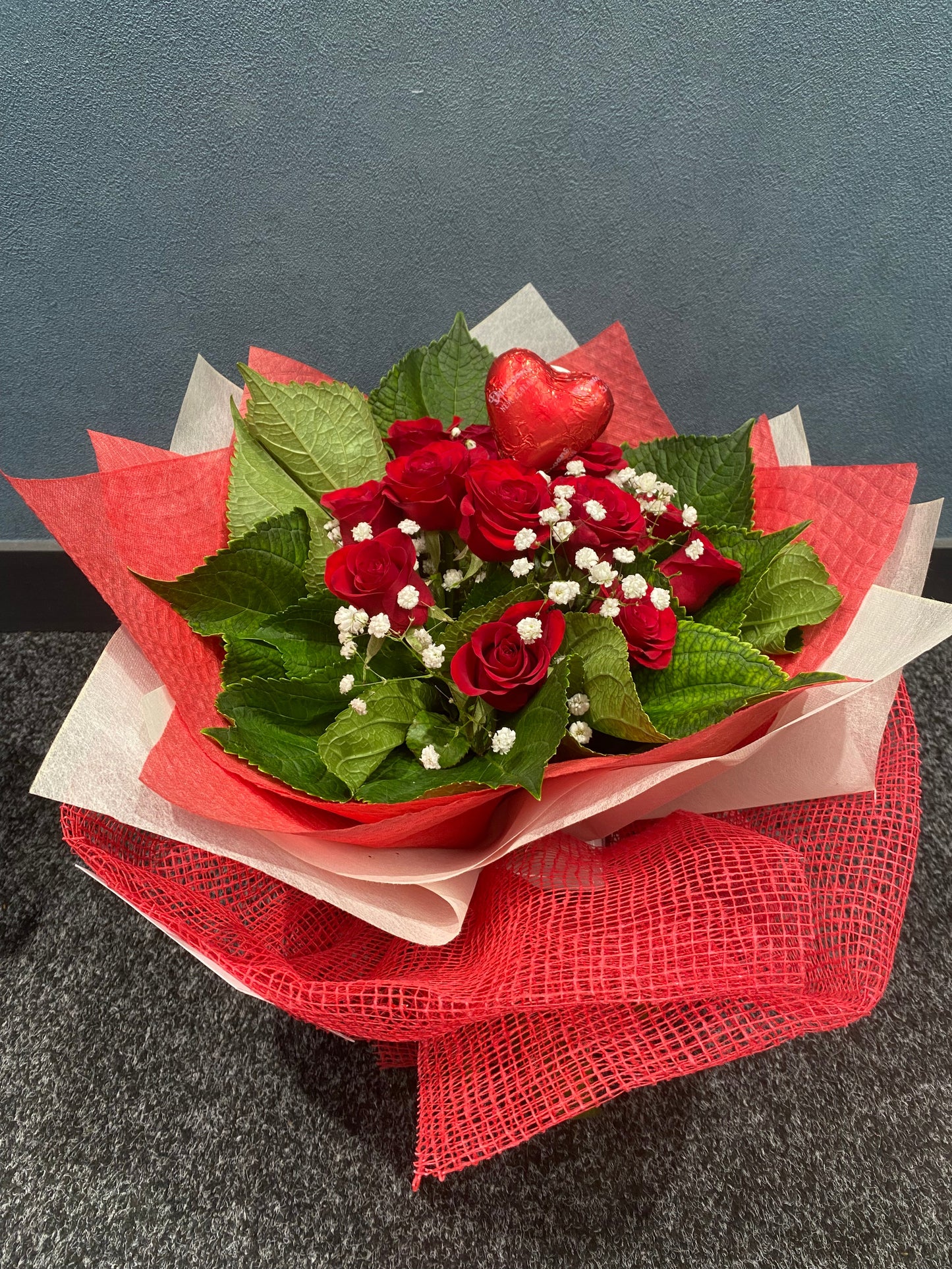 Bouquet of red roses with green leaves            