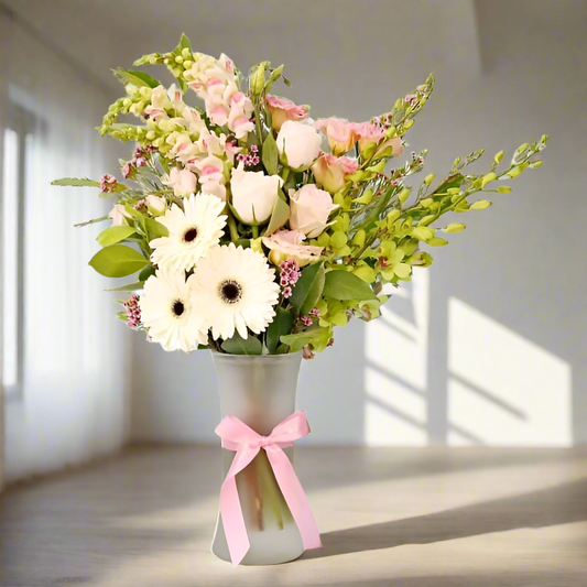Bouquet of flowers in a vase with a pink bow