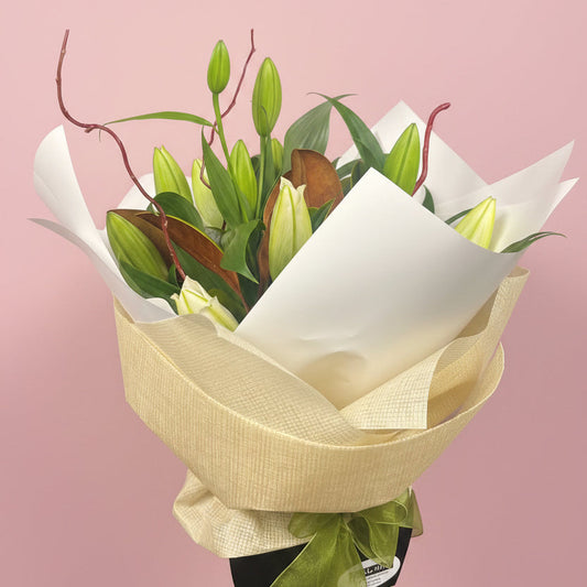 Bouquet of flowers wrapped in white paper