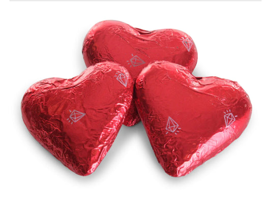 Three red heart-shaped chocolates