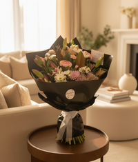 Bouquet of flowers wrapped in black paper