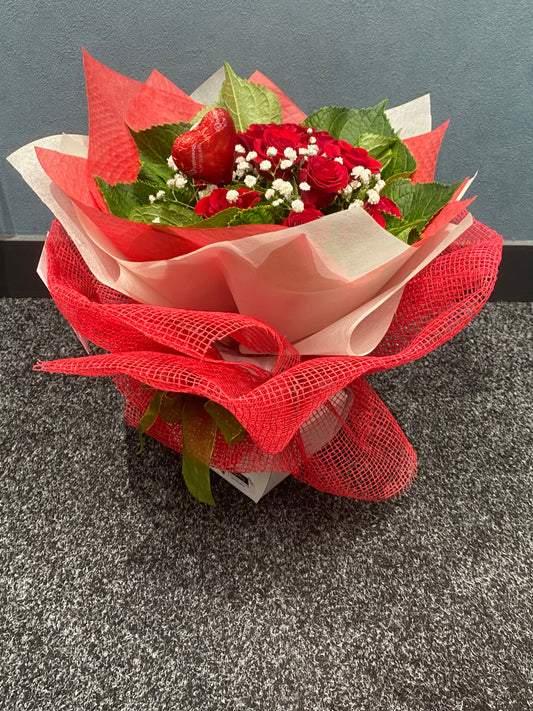 Bouquet of red roses with green leaves