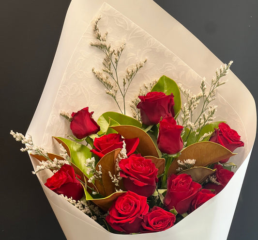 Bouquet of red roses wrapped in white paper
